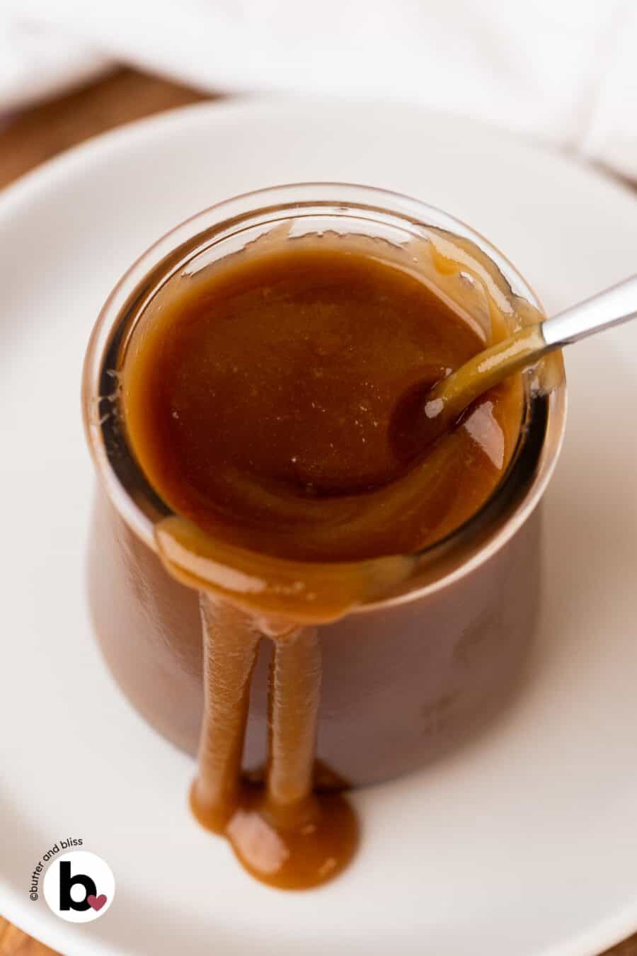 Maple caramel in a small jar with drips off the side.