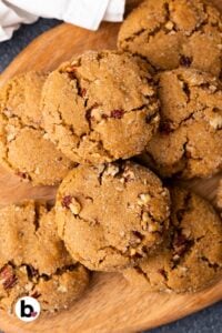 Small batch pecan brown sugar cookies piled on a wood plate.