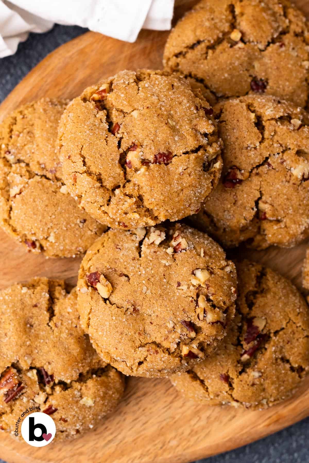 Small batch pecan brown sugar cookies piled on a wood plate.
