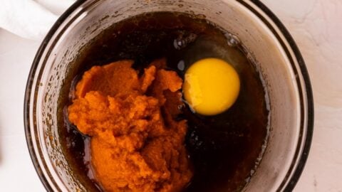 Wet ingredients for pumpkin bars in a mixing bowl.
