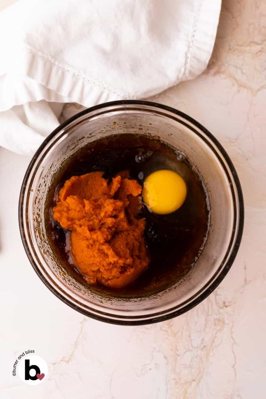 Wet ingredients for pumpkin bars in a mixing bowl.