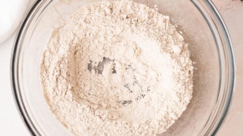 A well made in the center of dry ingredients in a mixing bowl.