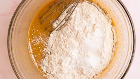 Dry ingredients sifted over wet blondie ingredients in a small mixing bowl.