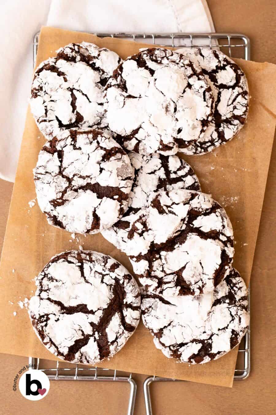 Small batch chocolate crinkle cookies piled on a wire cooling rack.