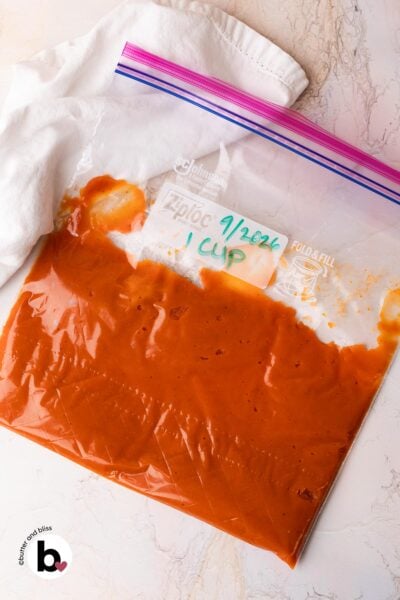Leftover pumpkin puree in a Ziploc bag for freezing, with date written on the bag.