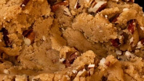 Maple brown sugar cookie dough studded with pecans in a mixing bowl.