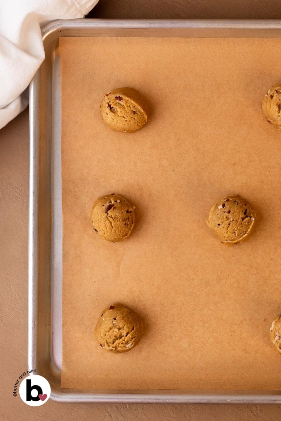 Maple brown sugar cookie dough balls on a baking sheet.