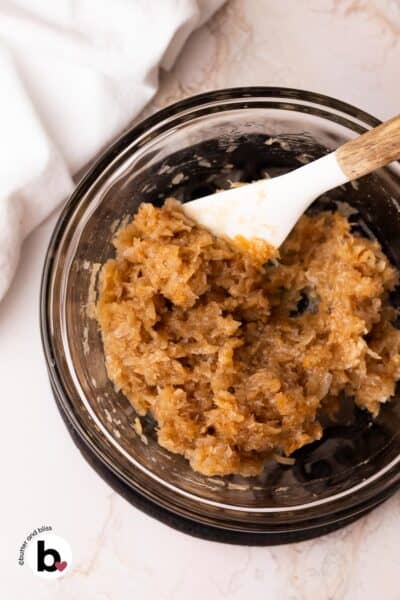 Maple macaroons dough in a mixing bowl with a spatula.