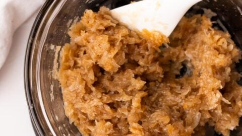 Maple macaroons dough in a mixing bowl with a spatula.