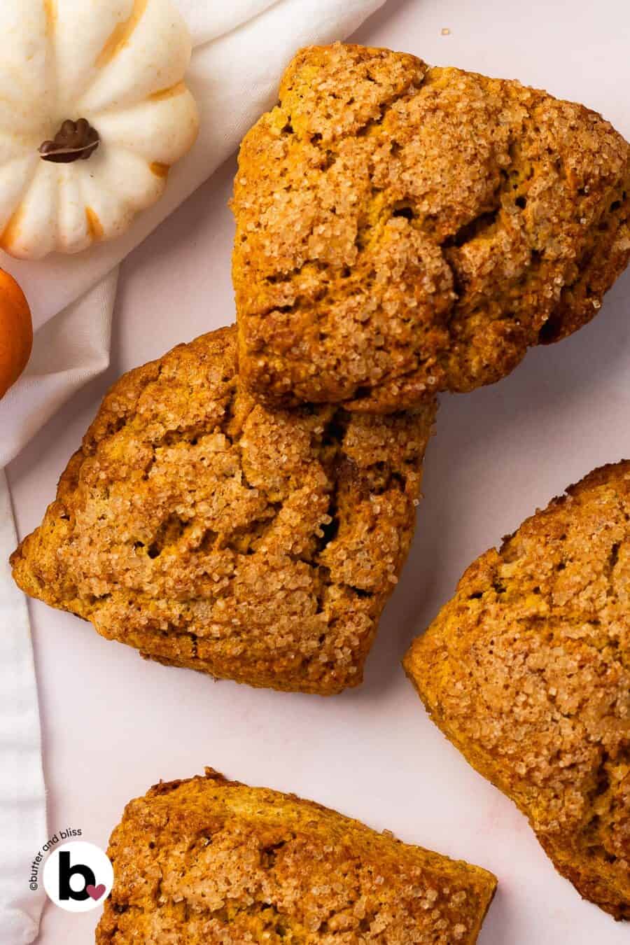 Fresh baked small batch pumpkin spice scones arranged on a table.